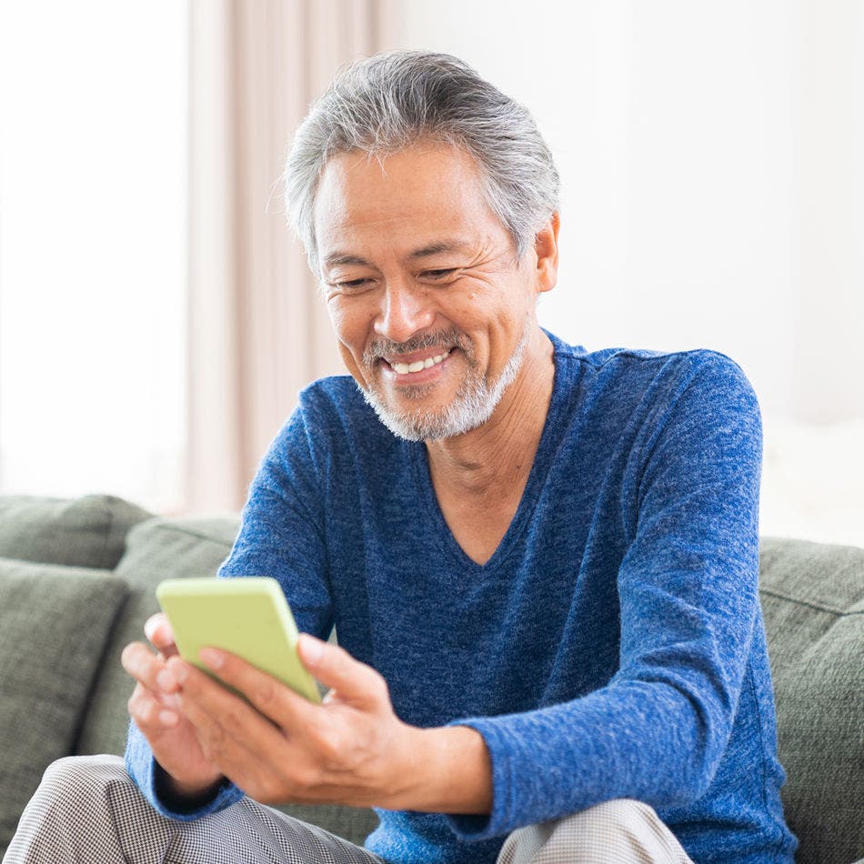 man using smartphone at home