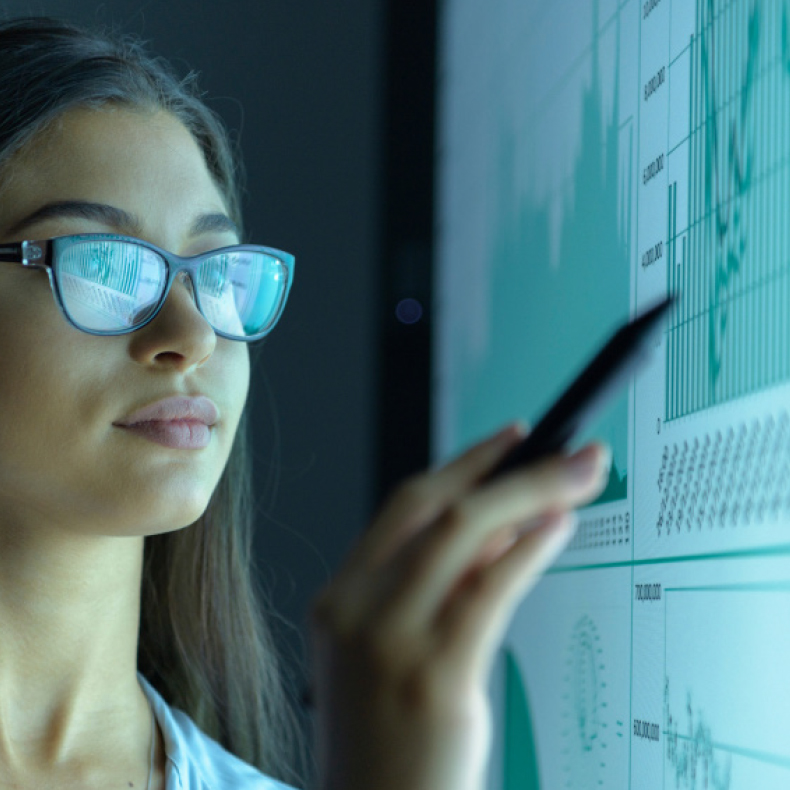 person with glasses looking at screen